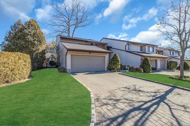 view of front of home with a garage and a front lawn