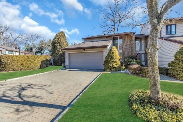 view of front of house with a garage and a front lawn