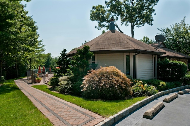 view of property exterior with a lawn