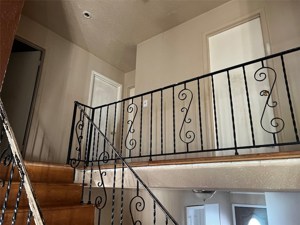 staircase with a textured ceiling