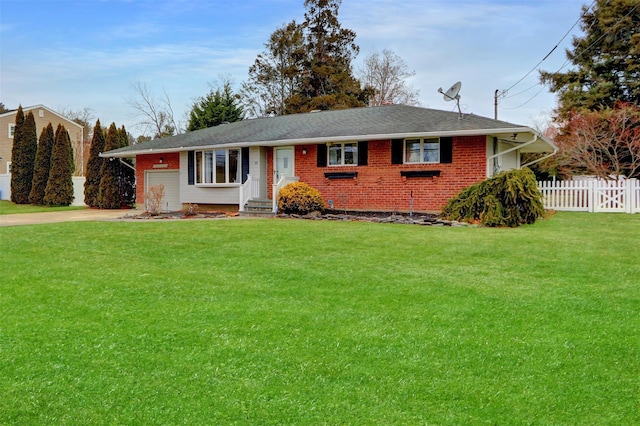 ranch-style house featuring a garage and a front lawn