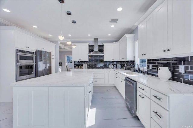 kitchen with a center island, sink, decorative light fixtures, white cabinetry, and stainless steel appliances