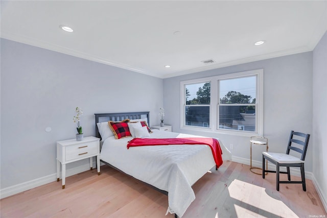 bedroom with ornamental molding and light wood-type flooring