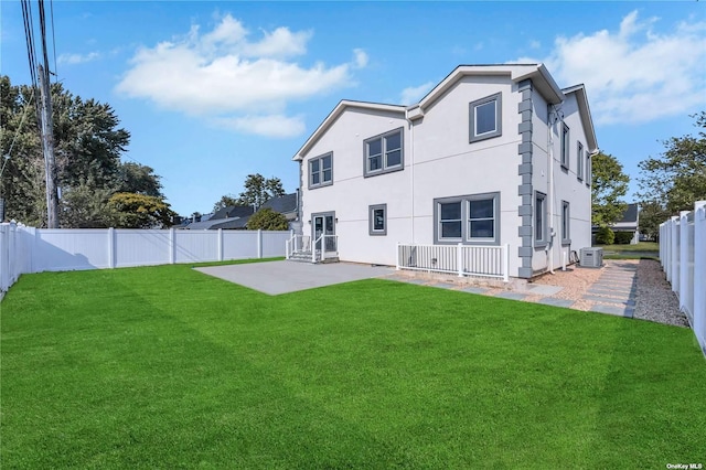 back of property featuring a yard, a patio area, and central air condition unit