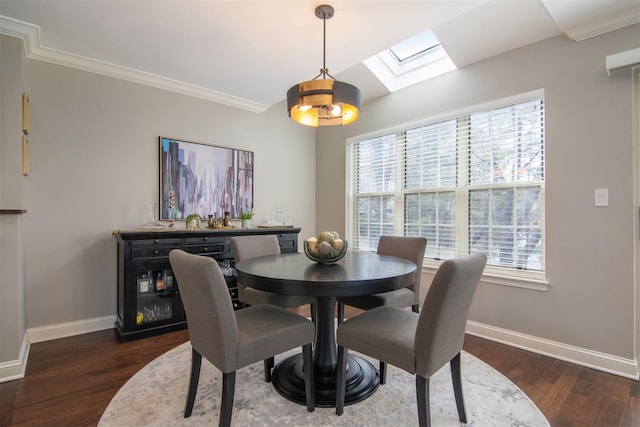 dining space featuring ornamental molding, lofted ceiling with skylight, and dark hardwood / wood-style flooring