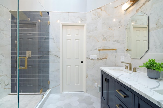 bathroom with vanity, tile walls, and a shower with shower door