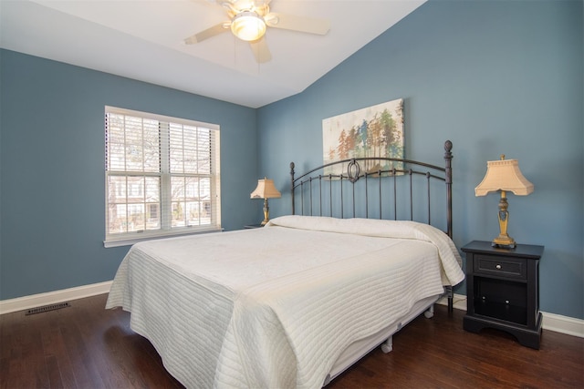 bedroom with dark wood-type flooring, vaulted ceiling, and ceiling fan