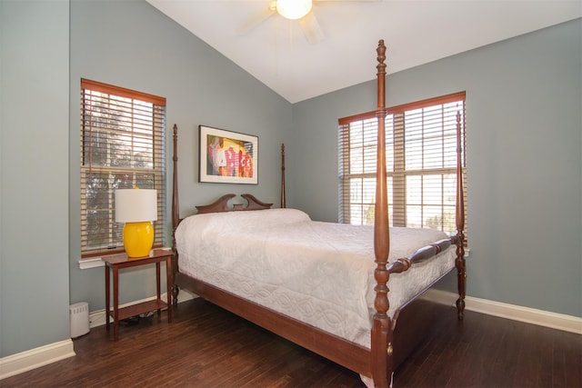 bedroom featuring dark wood-type flooring, ceiling fan, vaulted ceiling, and multiple windows