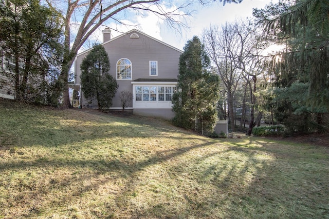 rear view of house with a lawn