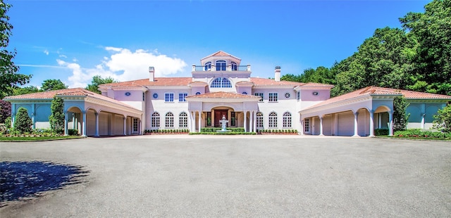 mediterranean / spanish-style home with a garage