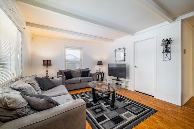 living room featuring beamed ceiling and hardwood / wood-style floors