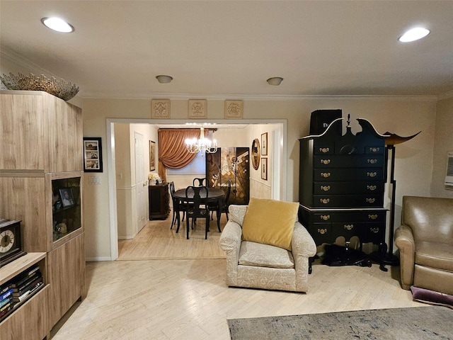 living room with light hardwood / wood-style floors, a chandelier, and ornamental molding