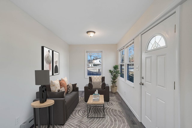 living room with baseboard heating and dark hardwood / wood-style flooring