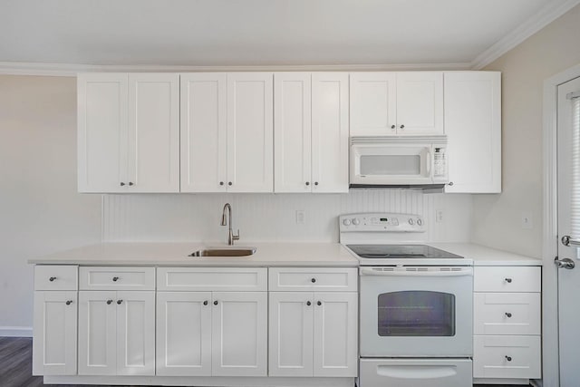 kitchen with white cabinetry, sink, dark hardwood / wood-style flooring, crown molding, and white appliances