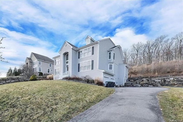 view of front of home with a front lawn and a garage