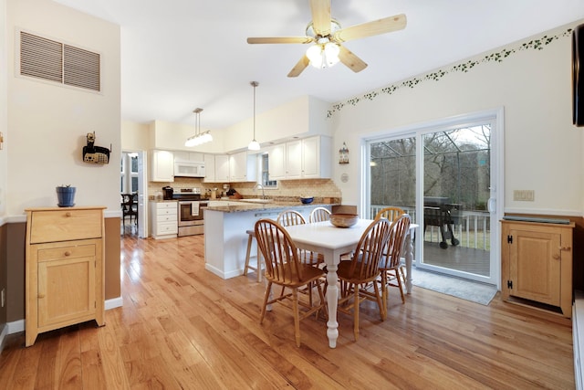 dining area with ceiling fan, sink, and light hardwood / wood-style floors