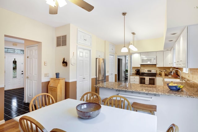 dining room featuring sink and ceiling fan