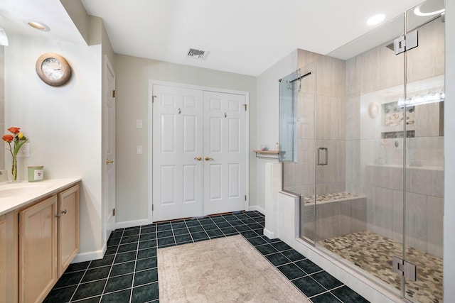 bathroom featuring vanity, an enclosed shower, and tile patterned floors