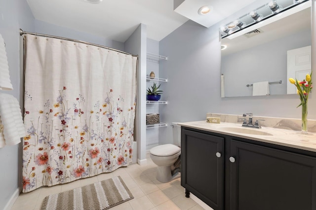 bathroom with vanity, toilet, and tile patterned flooring