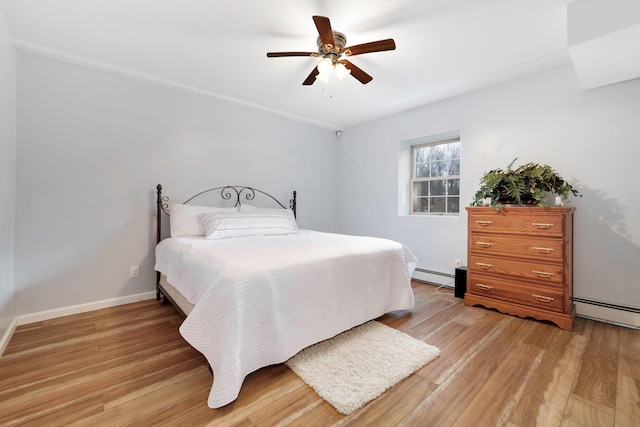 bedroom with a baseboard radiator, ceiling fan, and light hardwood / wood-style flooring