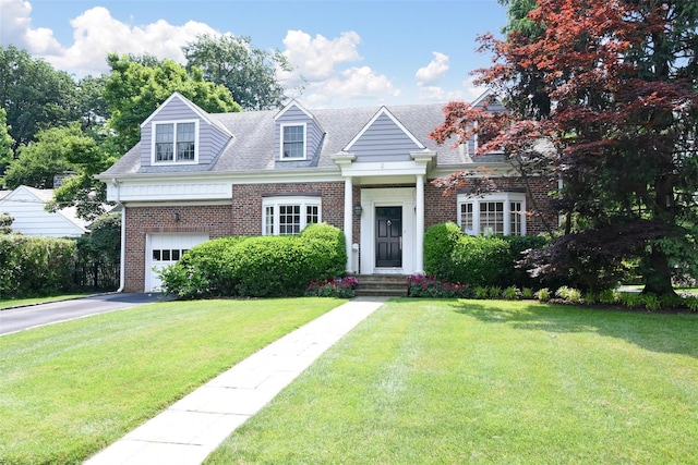 view of front of house with a front lawn and a garage