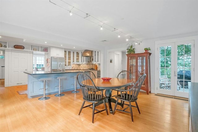 dining space featuring light wood-type flooring and sink