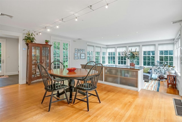 dining space featuring light wood-type flooring