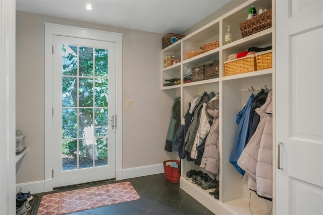 mudroom featuring dark tile patterned floors and a wealth of natural light