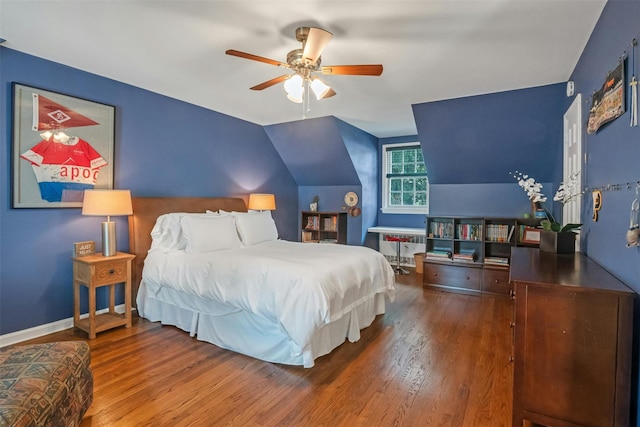 bedroom featuring ceiling fan, lofted ceiling, and wood-type flooring