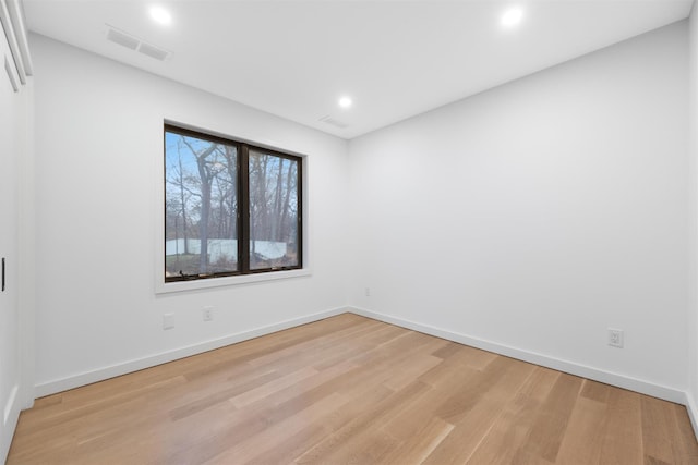 empty room with light hardwood / wood-style flooring