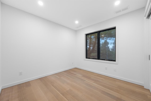 unfurnished room with light hardwood / wood-style floors