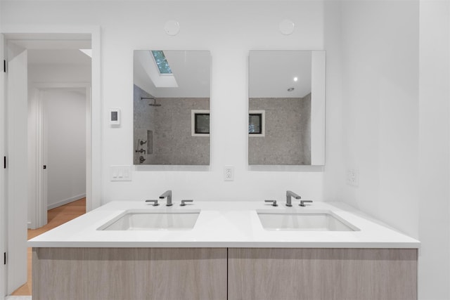 bathroom featuring vanity and a skylight