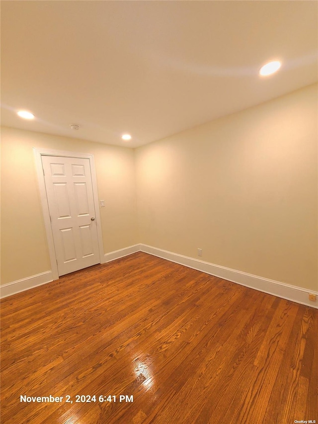 spare room featuring wood-type flooring