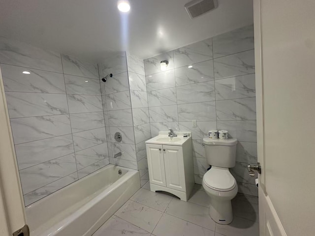 full bathroom with vanity, toilet, and tiled shower / bath