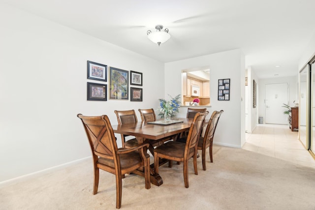 dining space with light carpet