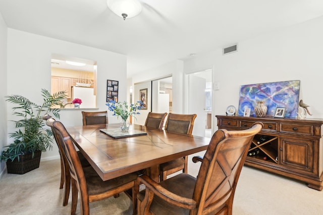 dining area with light colored carpet