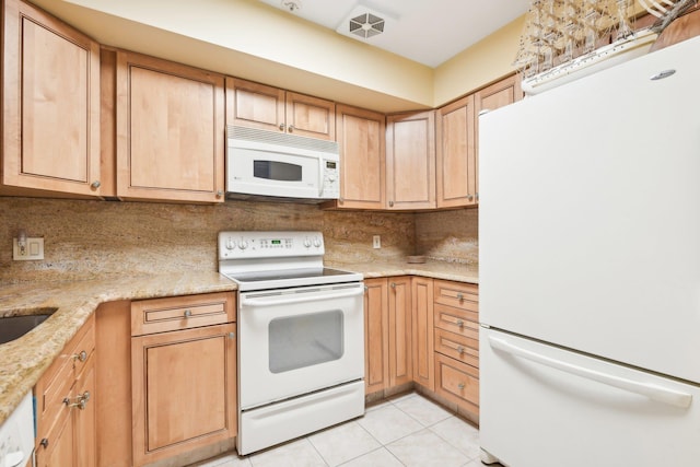 kitchen with tasteful backsplash, light stone counters, white appliances, light brown cabinets, and light tile patterned flooring