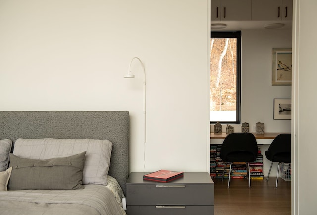 bedroom with dark wood-type flooring