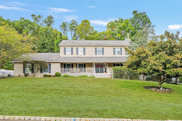 view of front facade with covered porch and a front lawn