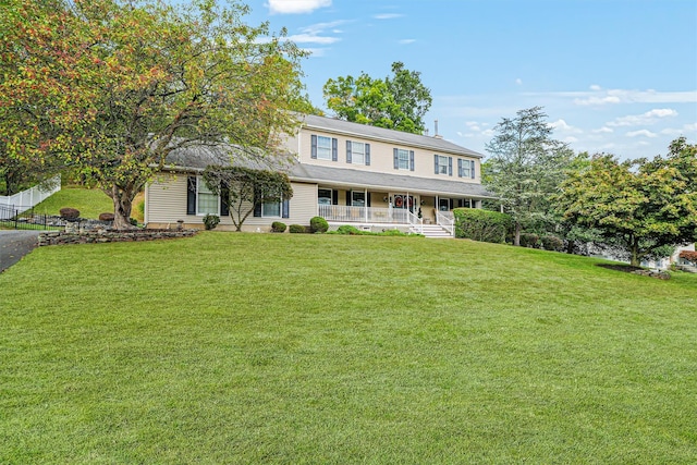 view of front of property with covered porch and a front lawn