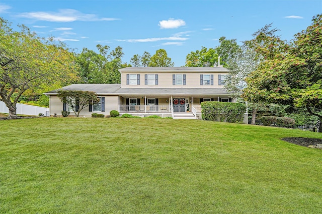 colonial house featuring covered porch and a front lawn