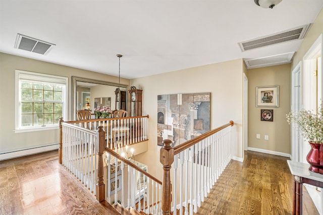 hallway featuring hardwood / wood-style floors and a baseboard radiator