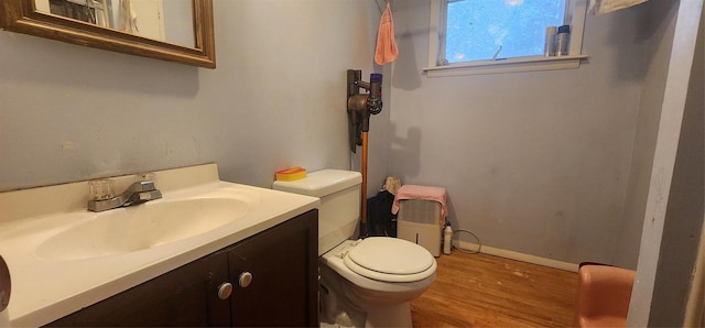 bathroom with vanity, toilet, and wood-type flooring