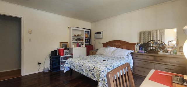 bedroom with a wall mounted air conditioner and dark wood-type flooring