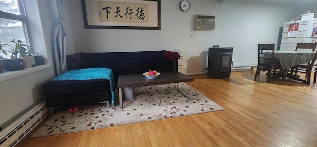 living room with a wall mounted air conditioner, wood-type flooring, and a baseboard radiator