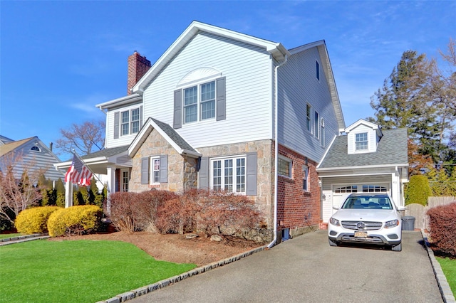 front of property featuring a front yard and a garage