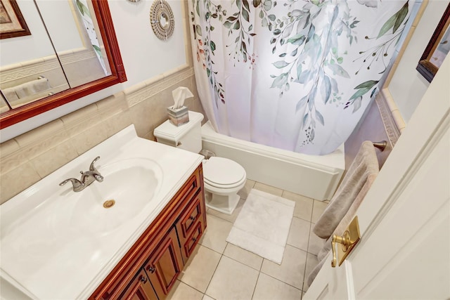 full bathroom featuring vanity, shower / bath combination with curtain, tile patterned flooring, toilet, and tile walls