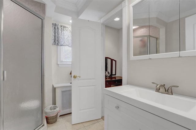 bathroom with tile patterned flooring, a shower with door, vanity, and ornamental molding