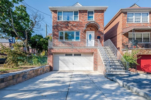 view of front of home with stairs, an attached garage, brick siding, and driveway