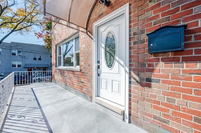 property entrance featuring brick siding